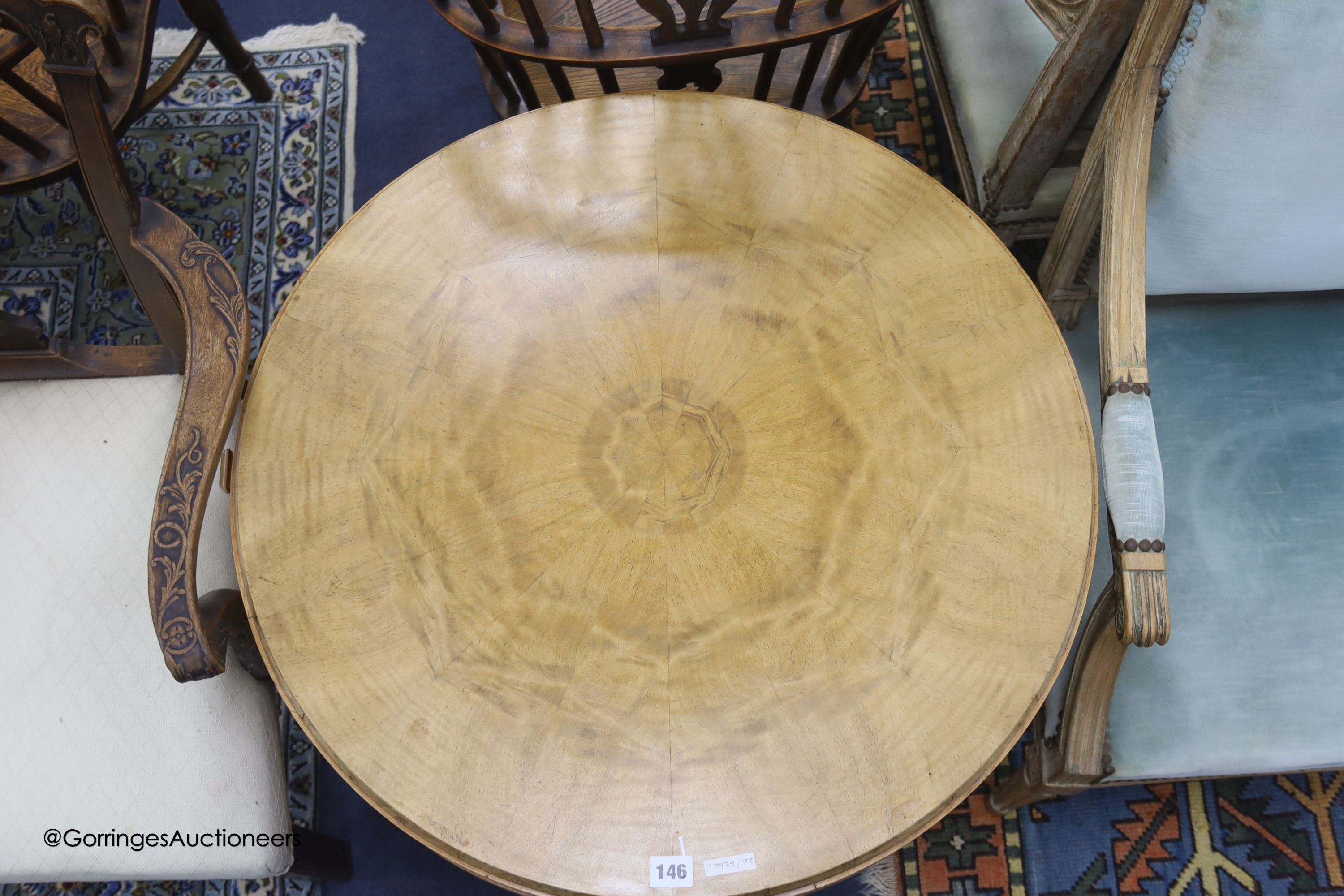 An Art Deco circular maple and bird's eye maple centre table with drawer leaves and open shelves